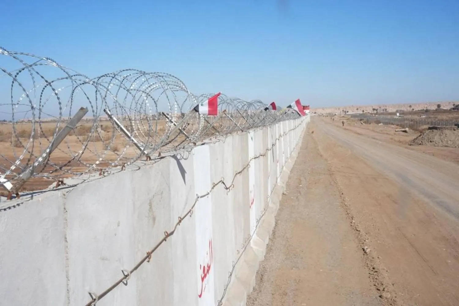 This handout photograph taken and released by the Iraqi Interior Ministry on January 28, 2024 shows a section of the border concrete wall, along the border with Syria in the Iraqi area of al-Baghouz, on the day of its inauguration. (Photo by Iraqi Interior Ministry / AFP)