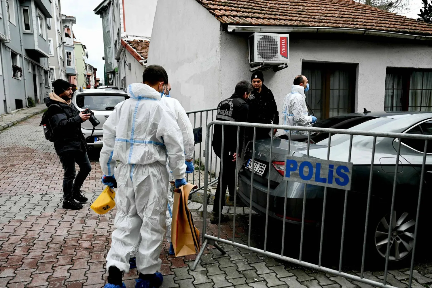 Turkish forensic police officers walk near Santa Maria church after an attack, in Istanbul, on January 28, 2024. (Photo by OZAN KOSE / AFP)