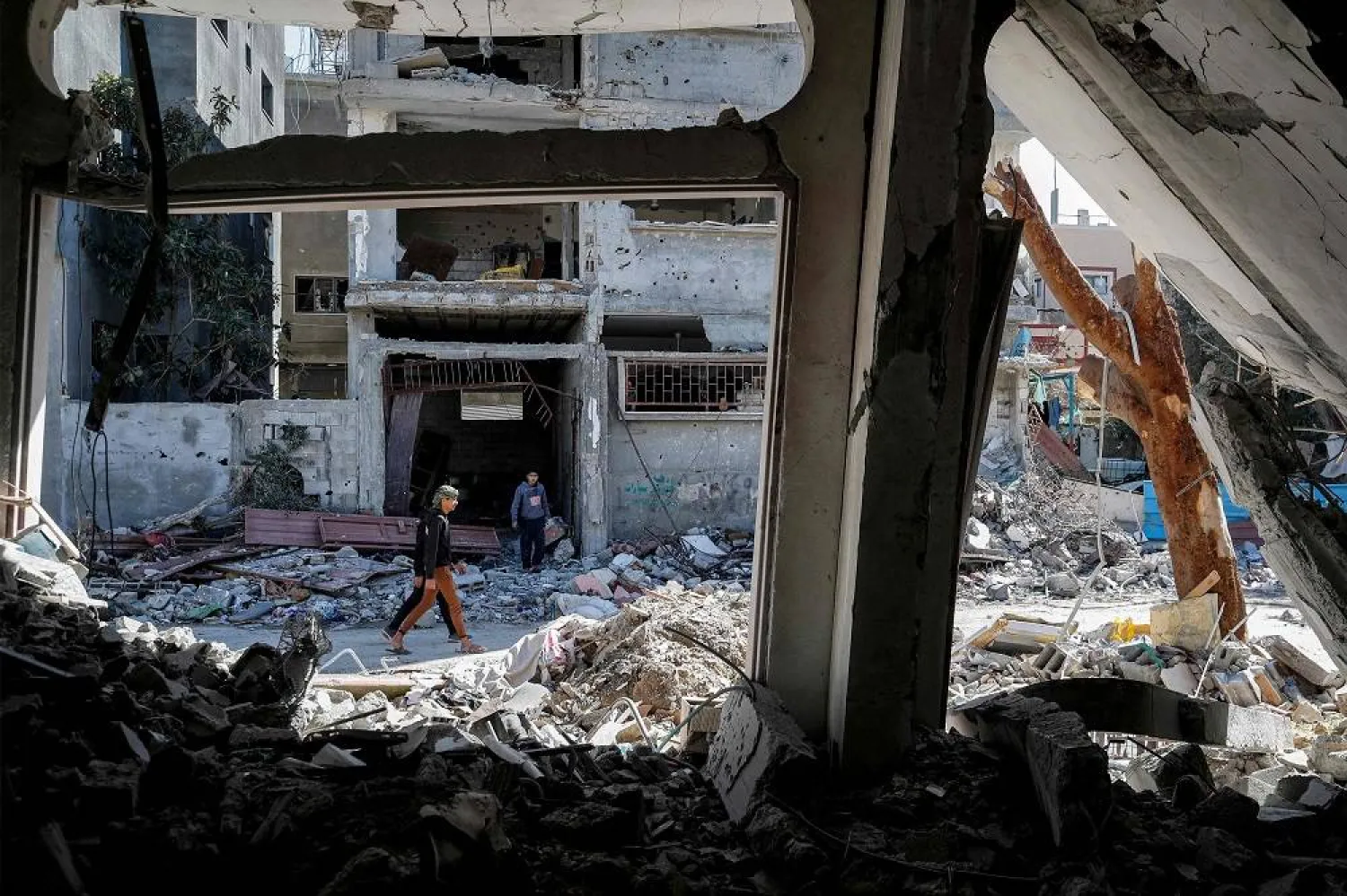 A man walks past the rubble of a destroyed building in the Maghazi camp for Palestinian refugees, which was severely damaged by Israeli bombardment amid the ongoing conflict in the Gaza Strip between Israel and the Palestinian militant group Hamas, in the central Gaza Strip on February 1, 2024. (AFP)