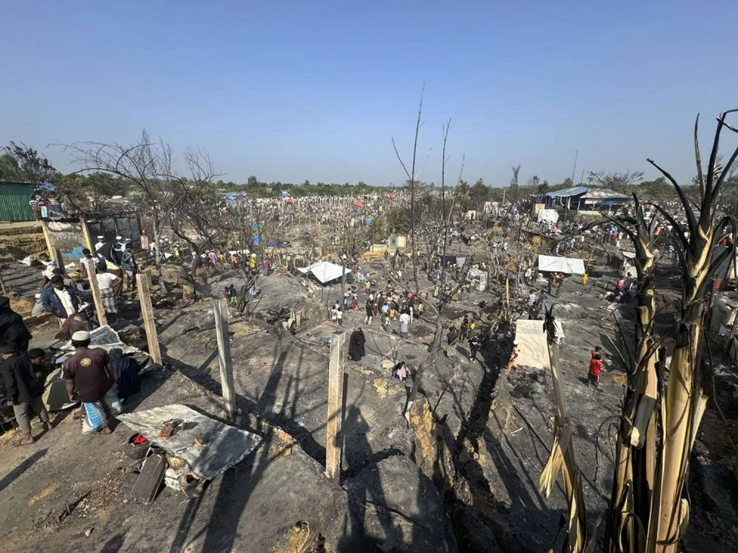  Rohingya refugees look on after a midnight fire raced through their refugee camp at Kutupalong in Cox's Bazar district, Bangladesh, Sunday, Jan. 7, 2024. (AP)