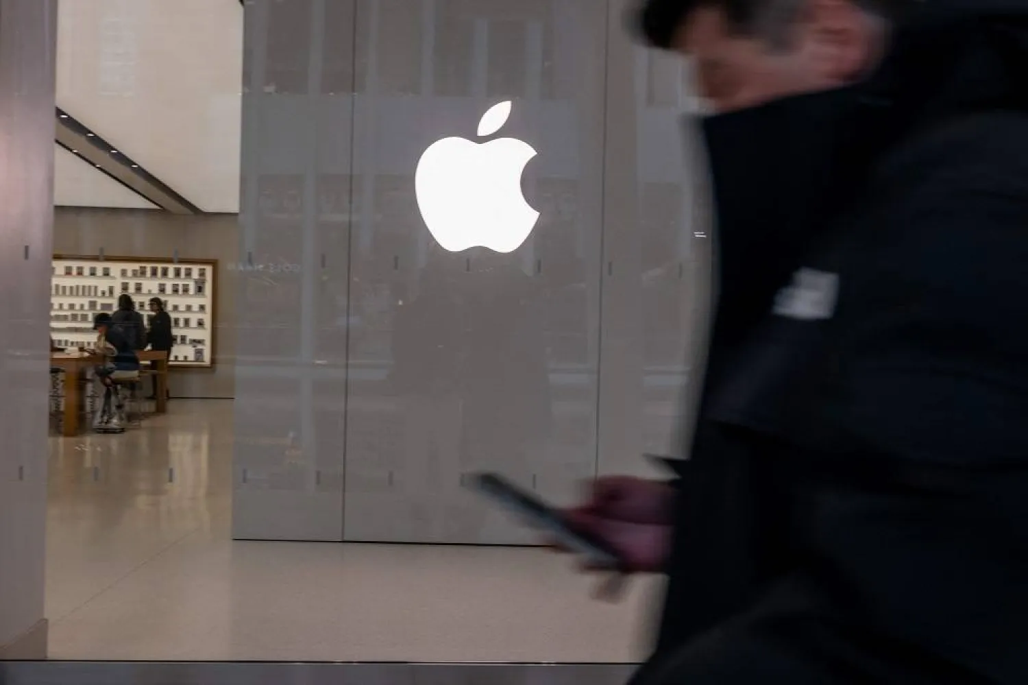 People walk by an Apple store in a shopping mall in lower Manhattan on February 01, 2024 in New York City. (Getty Images via AFP)