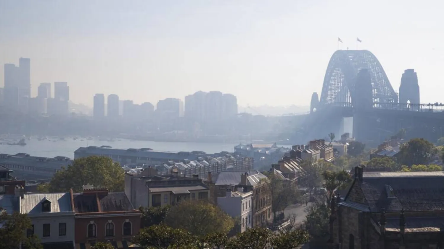 The Sydney Harbor Bridge is shrouded by smoke on September 13, 2023, after a ring of controlled fires burned in areas around the city in preparation for the looming bushfire season. (AFP)