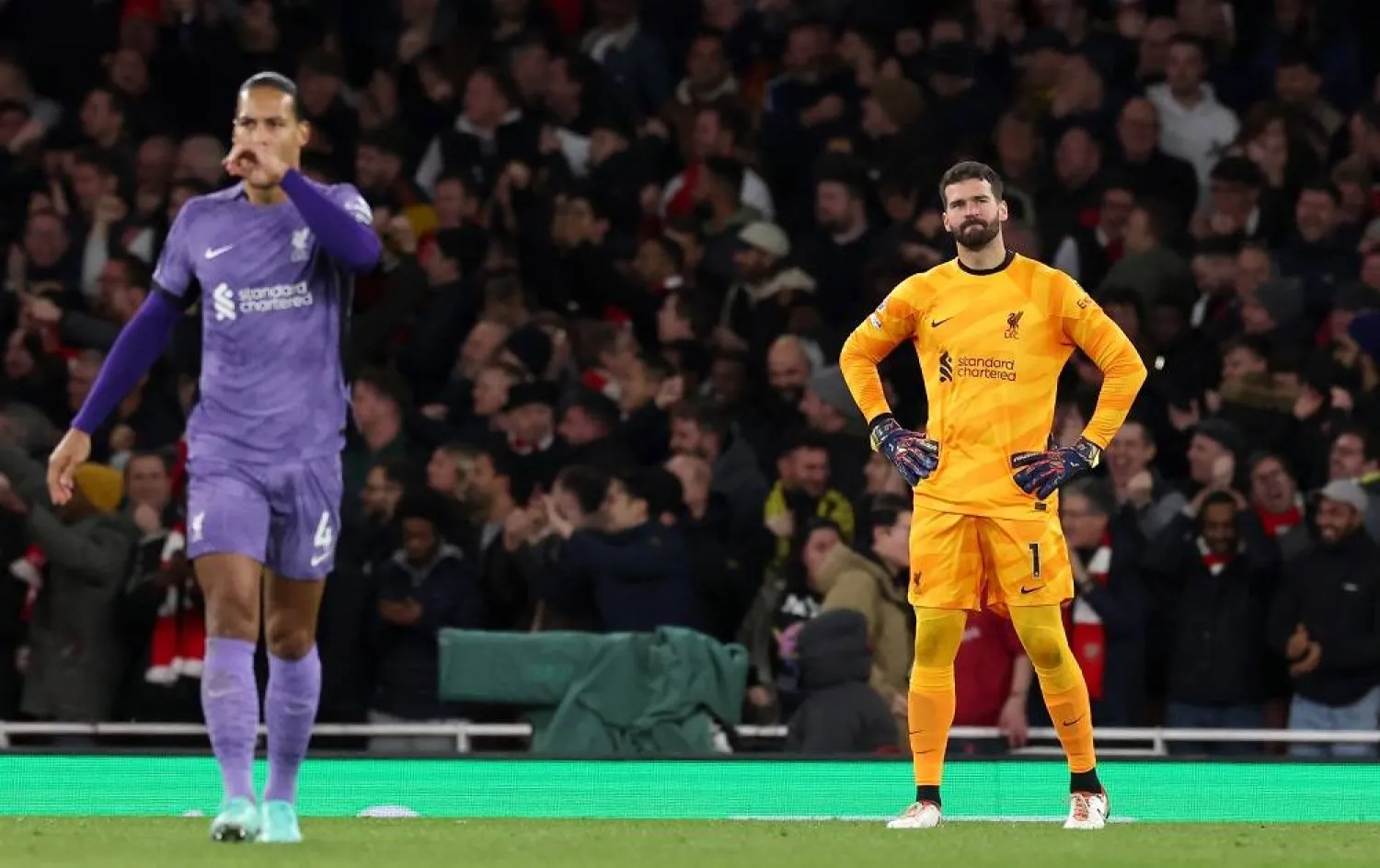 Liverpool goalkeeper Alisson Becker (R) and teammate Virgil van Dijk react after Arsenal scored their second goal during the English Premier League match between Arsenal FC and Liverpool FC, in London, Britain, 04 February 2024. (EPA) 