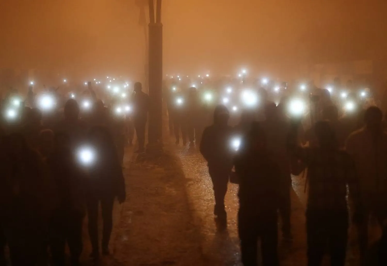  People march while holding lights during the first anniversary commemoration of the devastating earthquake that hit Türkiye and Syria, in Hatay, Türkiye, 06 February 2024. (EPA)