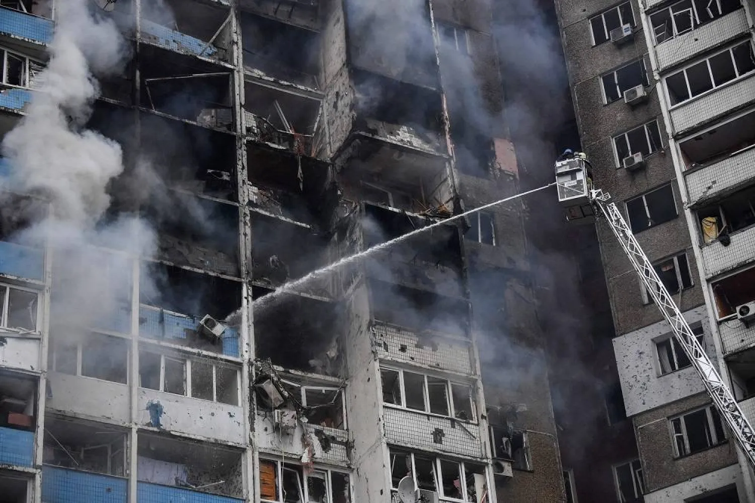 Ukrainian rescuers extinguish a fire in a residential building following a missile attack in Kyiv on February 7, 2024, amid the Russian invasion of Ukraine. (AFP)