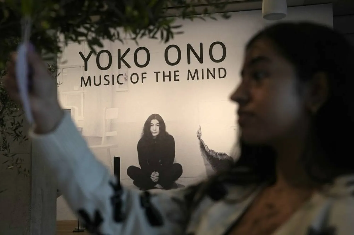 A member of staff hangs a note on a work entitled Wish Trees for London, first realisation Wish Tree 1996, exhibition realisation 2024, at the Yoko Ono : Music of the Mind exhibition at the Tate Modern, the works of art are copyright Yoko Ono, In London, Tuesday, Feb. 13, 2024. 