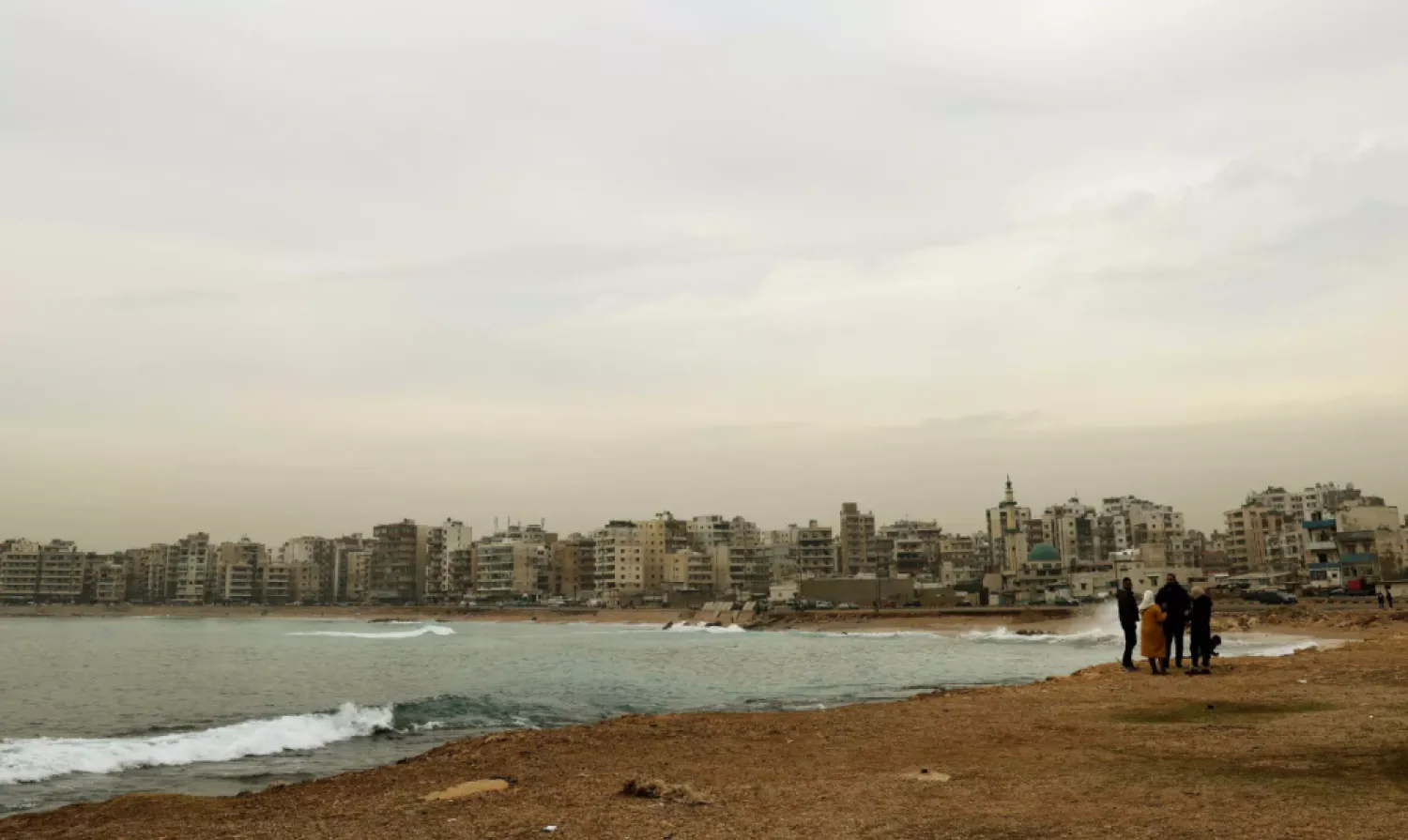 Lebanese walk along the shore in Tripoli -- the UN refugee agency says the number of Lebanese trying to take illicit sea journeys out of the country increased in 2021 JOSEPH EID AFP

