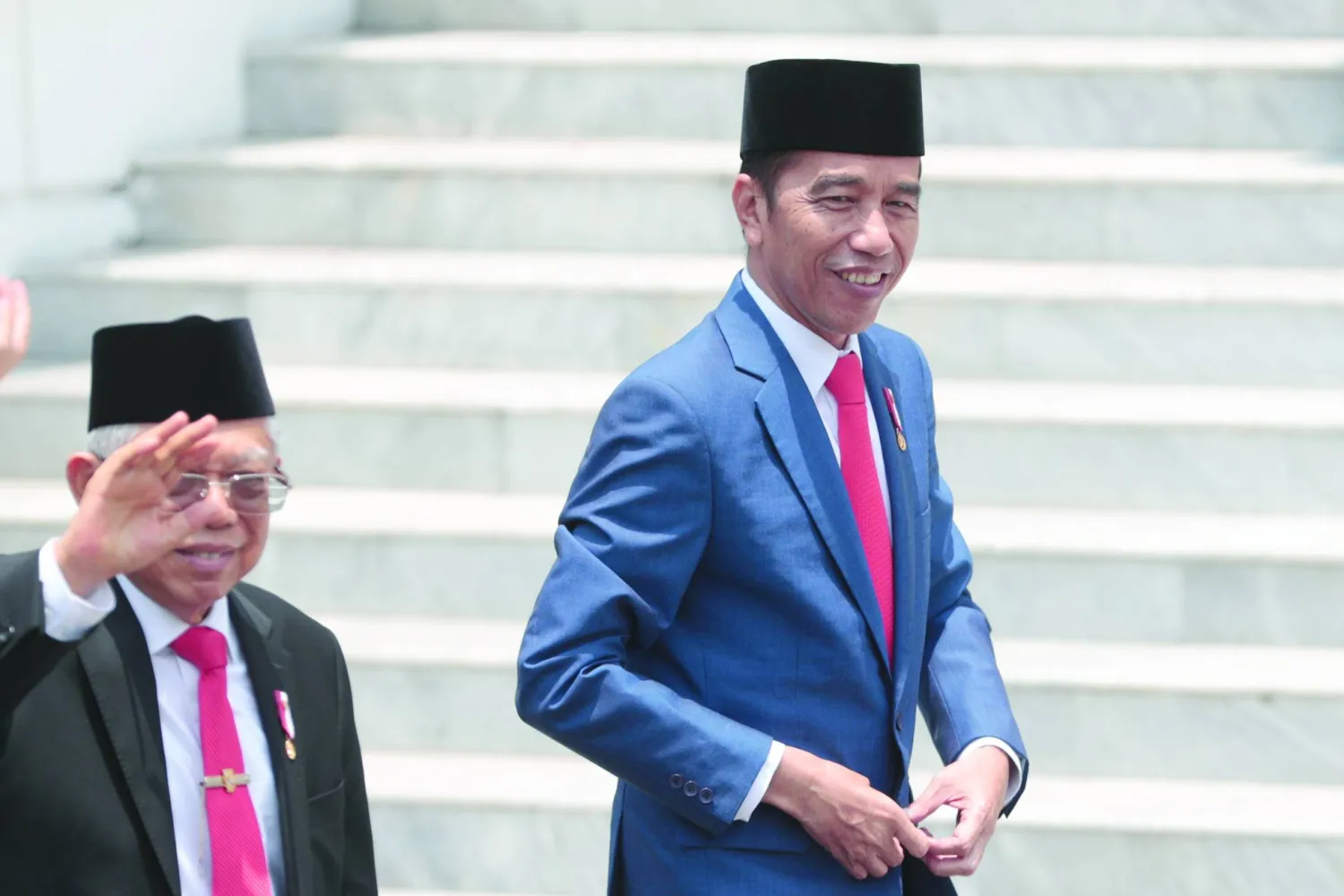 FILE - Indonesian President Joko Widodo, right, and his deputy Ma'ruf Amin arrive for a group photo with his new cabinet ministers after the swearing-in ceremony of the new cabinet at Merdeka Palace in Jakarta, Indonesia, Wednesday, Oct. 23, 2019. (AP Photo/Dita Alangkara, File)

