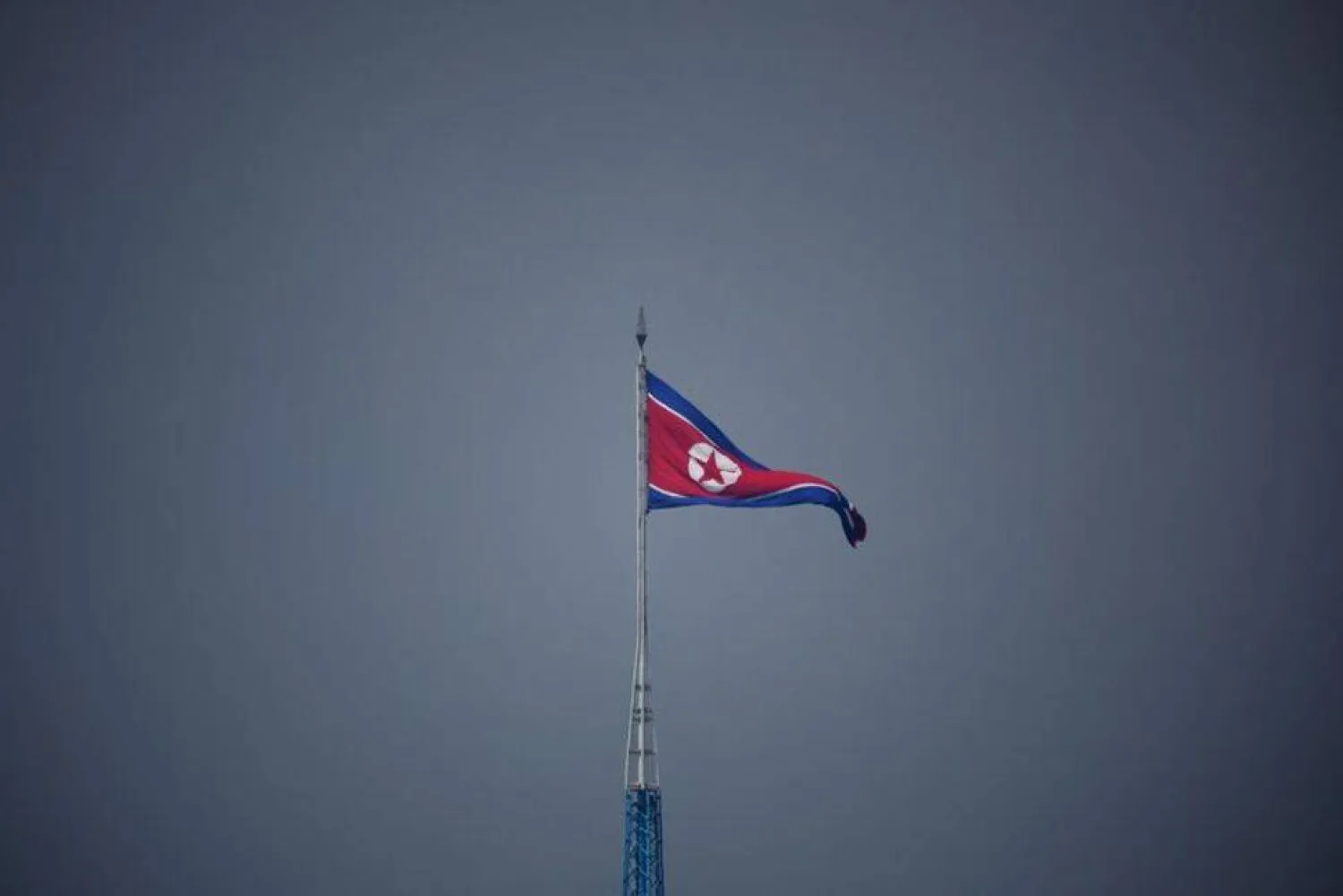 A North Korean flag flutters at the propaganda village of Gijungdong in North Korea, in this picture taken near the truce village of Panmunjom inside the demilitarized zone (DMZ) separating the two Koreas, South Korea, July 19, 2022. REUTERS/Kim Hong-Ji/Pool/ File Photo


