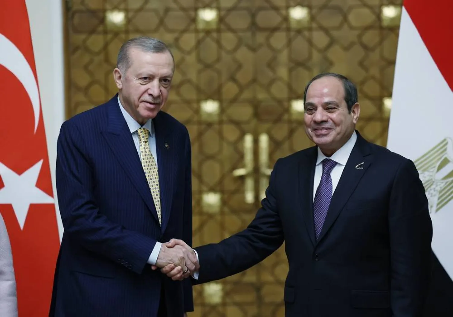 A handout photo made available by the Turkish President's Press Office shows Egyptian President Abdel Fattah al-Sisi (R) and Turkish President Recep Tayyip Erdogan (L) shaking hands during their meeting in Cairo, Egypt, 14 February 2024. (EPA/Turkish Presidential Press Office Handout) 