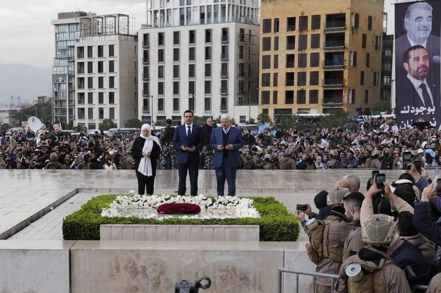 Former Prime Minister Saad Hariri, center, commemorates the 19th anniversary of his father's assassination by praying at his grave along with his aunt Bahia Hariri, left, and his uncle Chafik Hariri, right, in Beirut, Lebanon, Wednesday, Feb. 14, 2024. (AP) 
