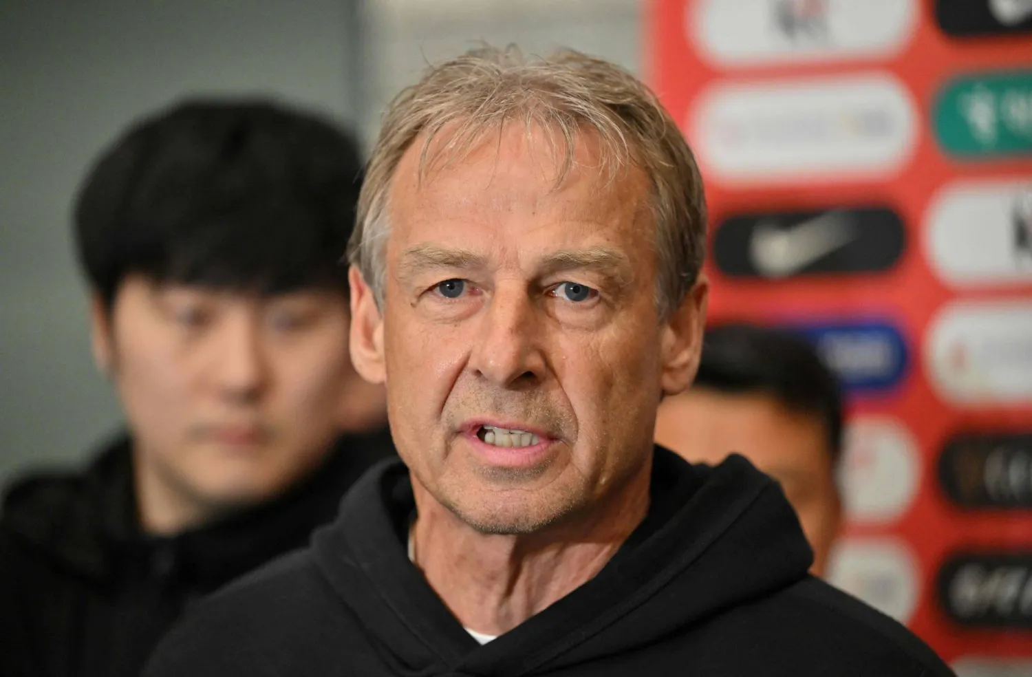 (FILES) South Korea's national football team head coach Jurgen Klinsmann speaks to reporters upon his arrival at Incheon International Airport in Incheon, west of Seoul, on February 8, 2024 after South Korea got knocked out of the semi-finals at the Asian Cup. (Photo by Jung Yeon-je / AFP)