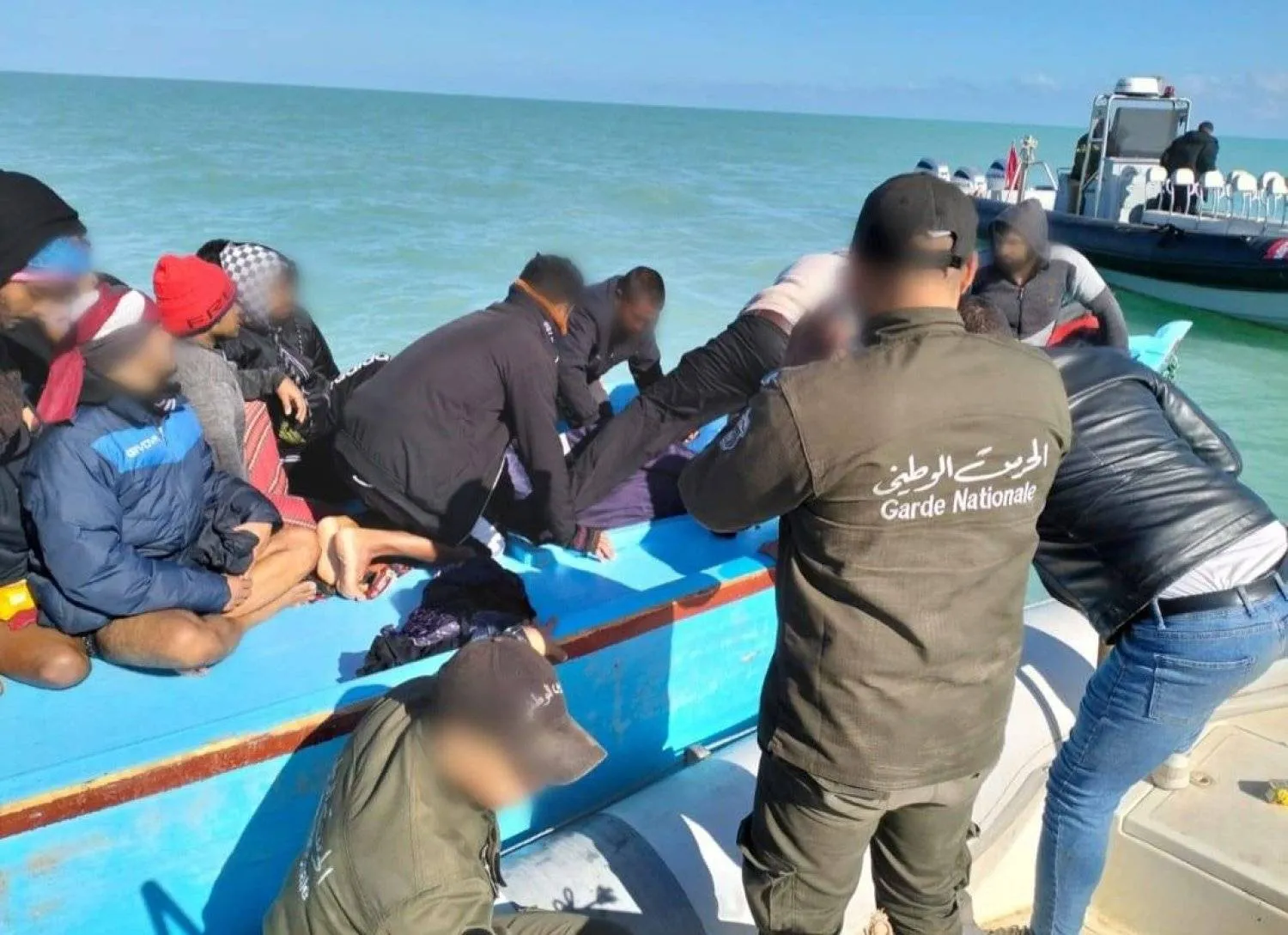 Tunisian rescuers help migrants. Photo: Tunisia National Guard Facebook page