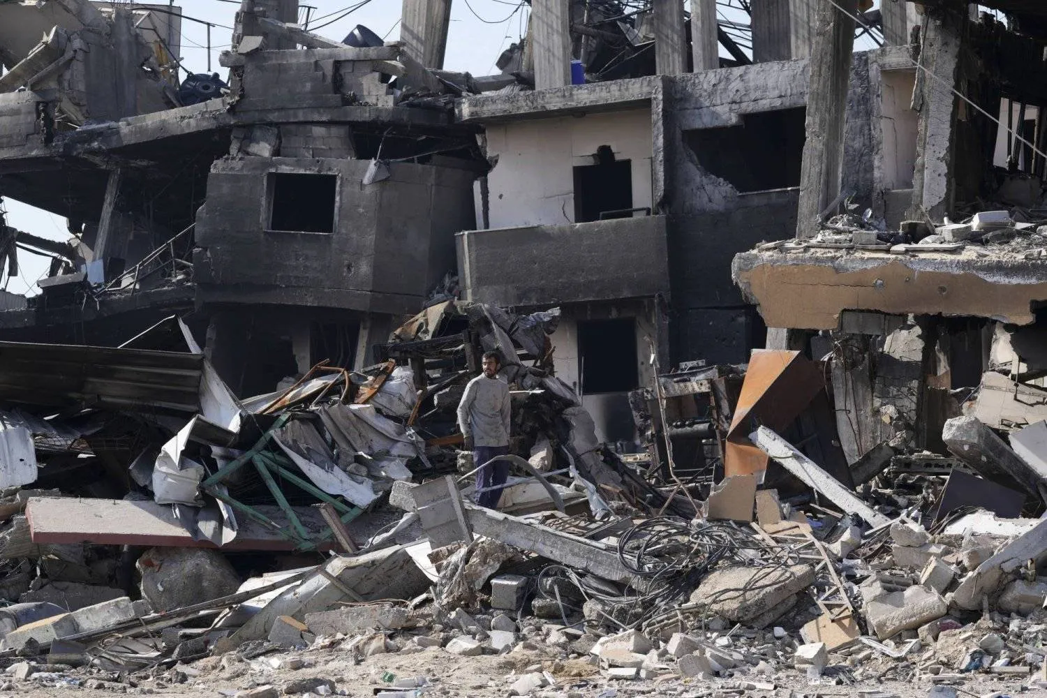 A Palestinian looks at the devastation caused by the Israeli bombing in the Maghazi refugee camp in the central Gaza Strip (AP)