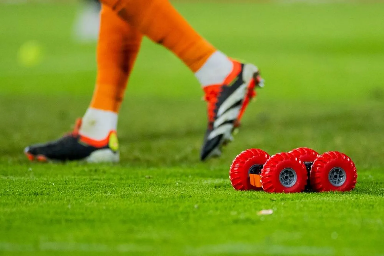 16 February 2024, North Rhine-Westphalia, Cologne: Remote-controlled cars drive on the pitch next to tennis balls during the German Bundesliga so0ccer match between 1. FC Cologne and Werder Bremen at RheinEnergieStadion. (dpa)