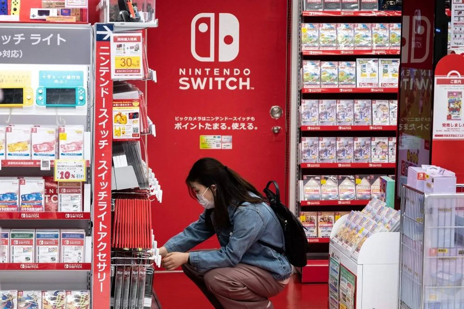 A customer browses the gaming section of Nintendo products in a shop in Tokyo, Japan, May 6, 2021. (AFP)