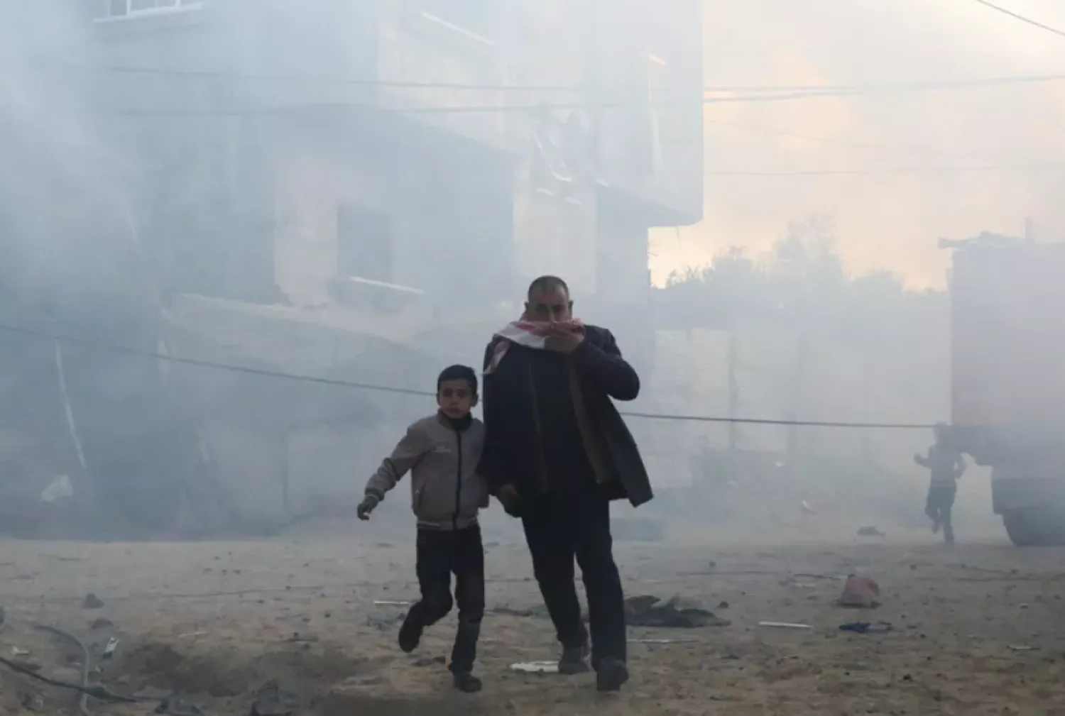 Palestinians run away after an Israeli strike on a residential building in Rafah, Monday, Feb. 19, 2024. (AP Photo/Hatem Ali)

