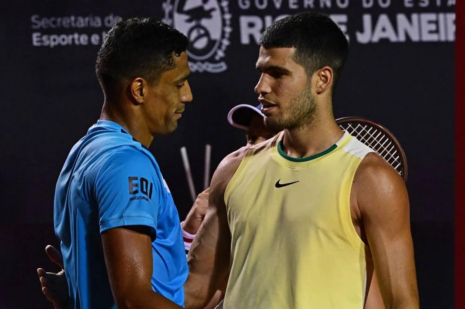 Spain's Carlos Alcaraz (R) and Brazil's Carlos Monteiro (L) greet after Alcaraz abandoned the ATP 500 Rio Open tennis match due to an injury, in Rio de Janeiro, Brazil on February 20, 2024. (AFP)