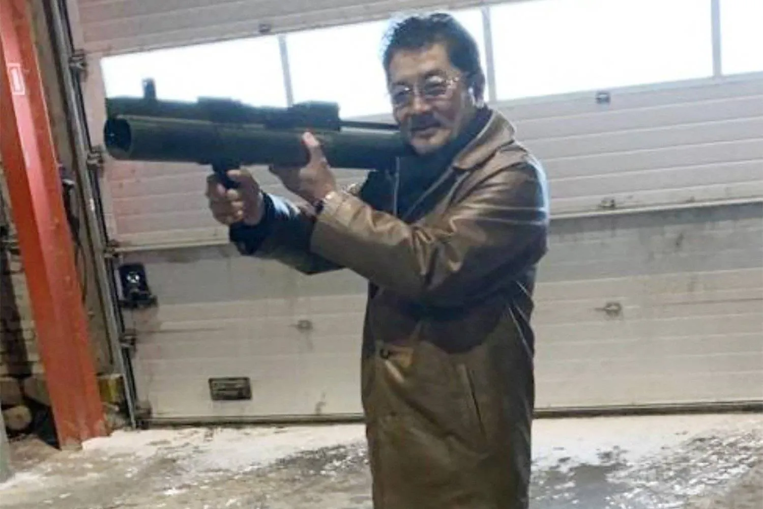 File photo: Takeshi Ebisawa poses with a rocket launcher during a meeting with an informant at a warehouse in Copenhagen in February 2021. (Reuters)