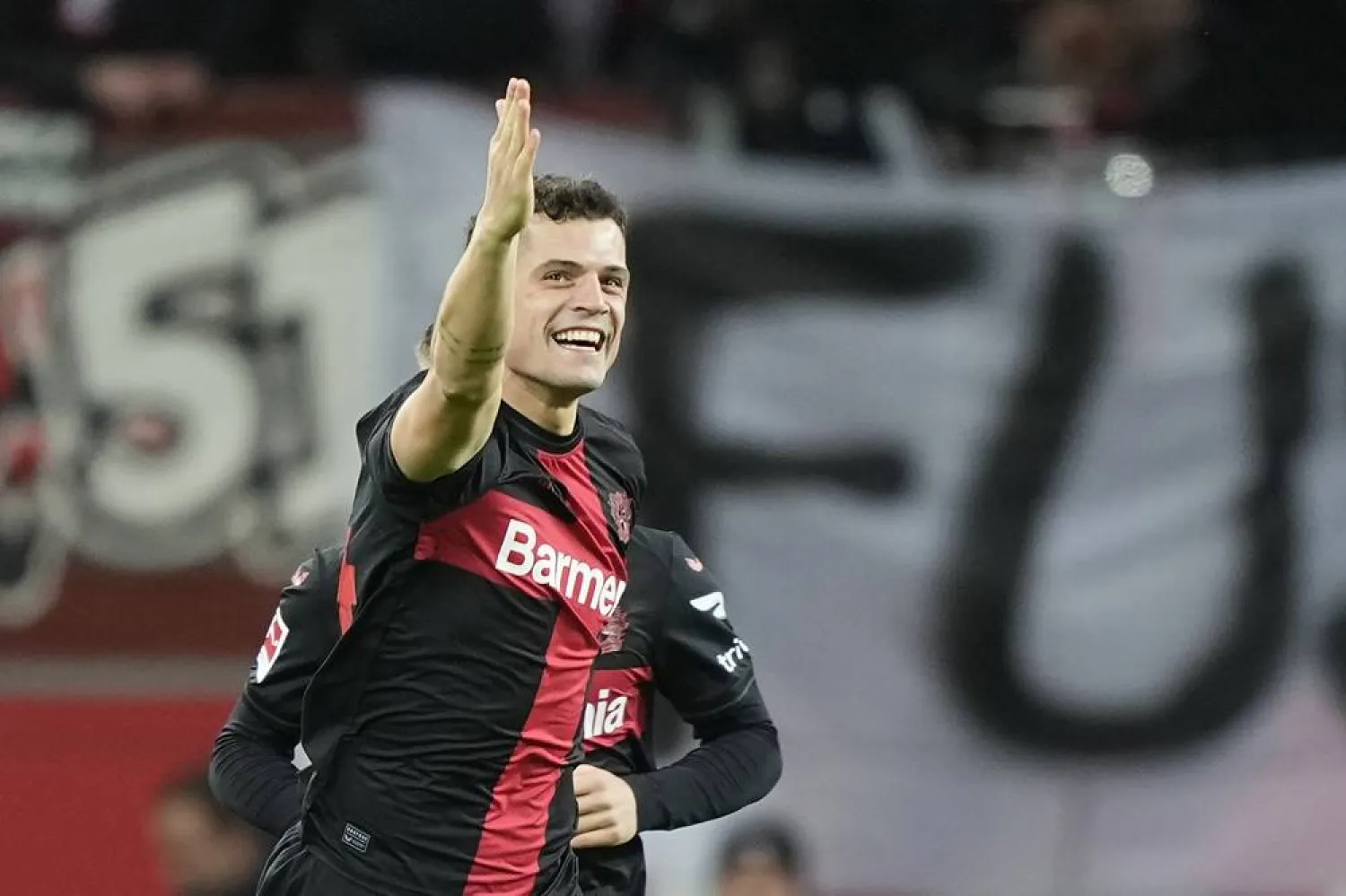  Leverkusen's Granit Xhaka celebrates after scoring the opening goal the German Bundesliga soccer match between Bayer 04 Leverkusen and 1. FSV Mainz 05 at the BayArena in Leverkusen, Germany, Friday, Feb. 23, 2024. (AP)