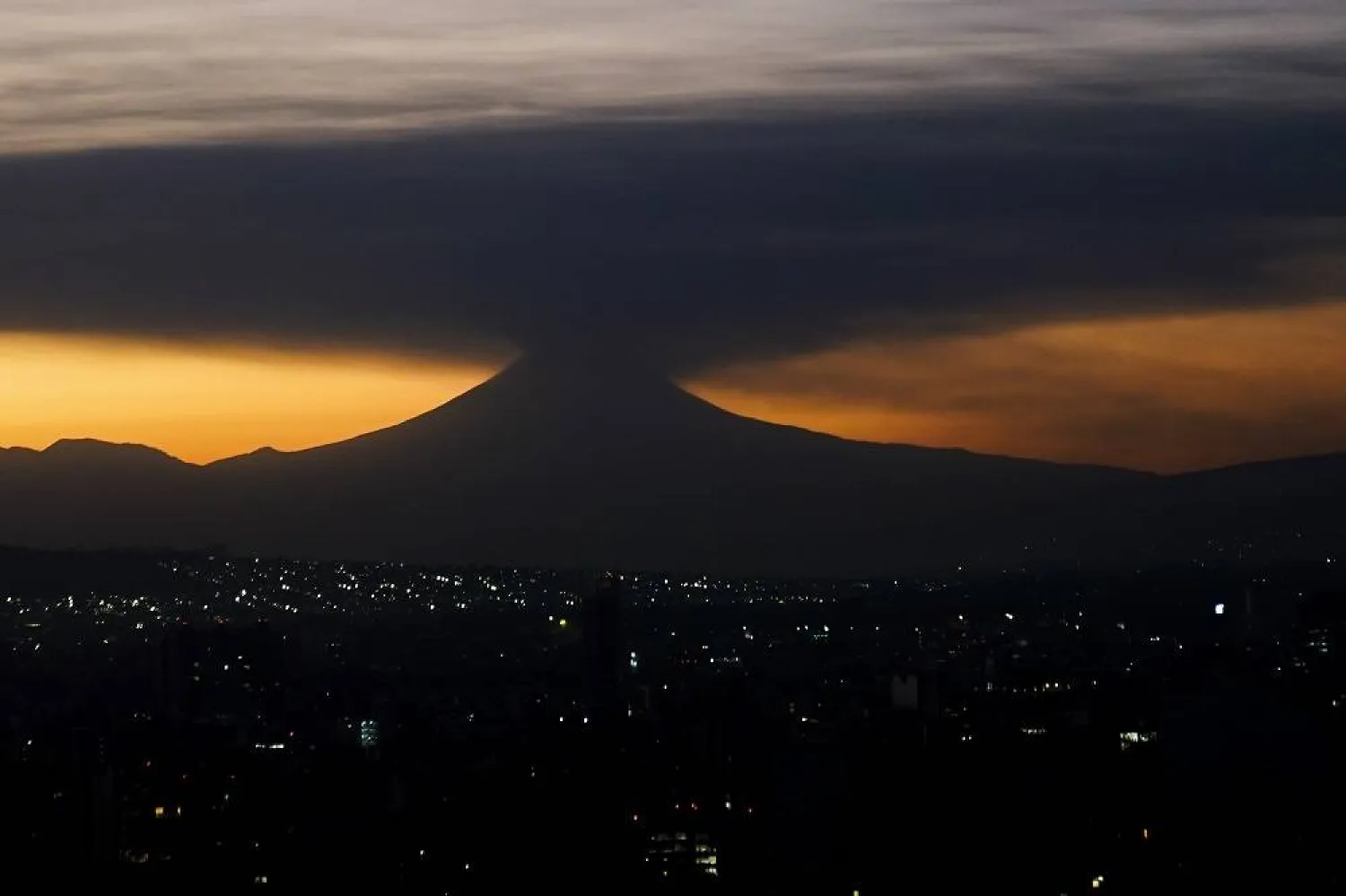 The Popocatepetl volcano emits smoke and ash, seen from Mexico City at sunrise on Tuesday, Feb. 27, 2024. (AP)