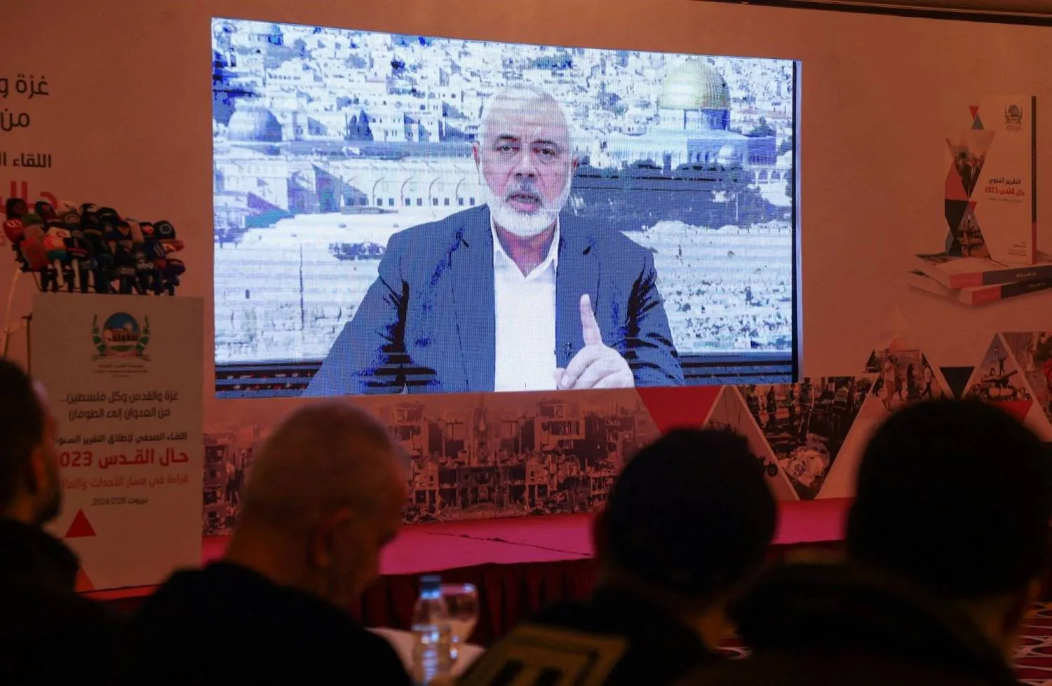 Hamas leader, Ismail Haniyeh, speaks in a pre-recorded message shown on a screen during a press event for Al Quds International Institution in Beirut, Lebanon February 28, 2024. (Reuters)