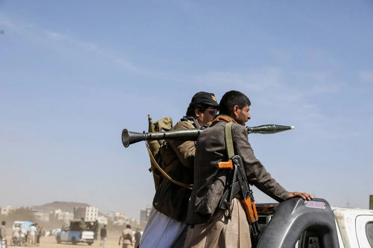 Armed Houthi followers ride on the back of a pick-up truck during a parade in solidarity with the Palestinians in the Gaza Strip and to show support to Houthi strikes on ships in the Red Sea and the Gulf of Aden, in Sanaa, Yemen January 29, 2024. (Reuters) 