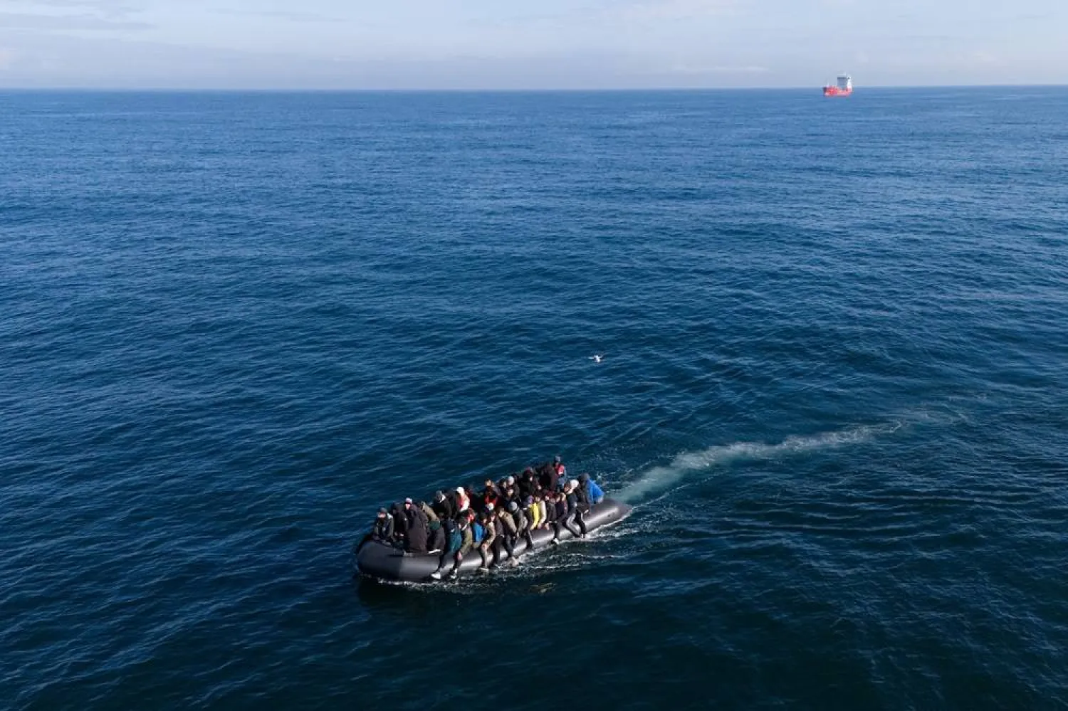 A picture taken with a drone shows migrants crossing the English Channel on a small boat, on 06 March 2024. (EPA)
