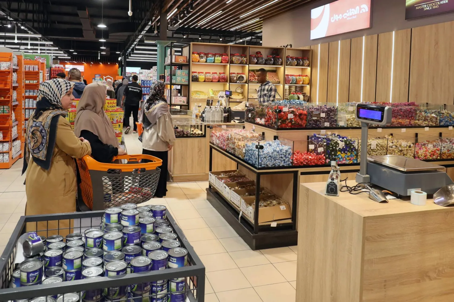 Libyans shop at a supermarket in Tripoli on February 24, 2024. (Photo by Mahmud Turkia / AFP)
