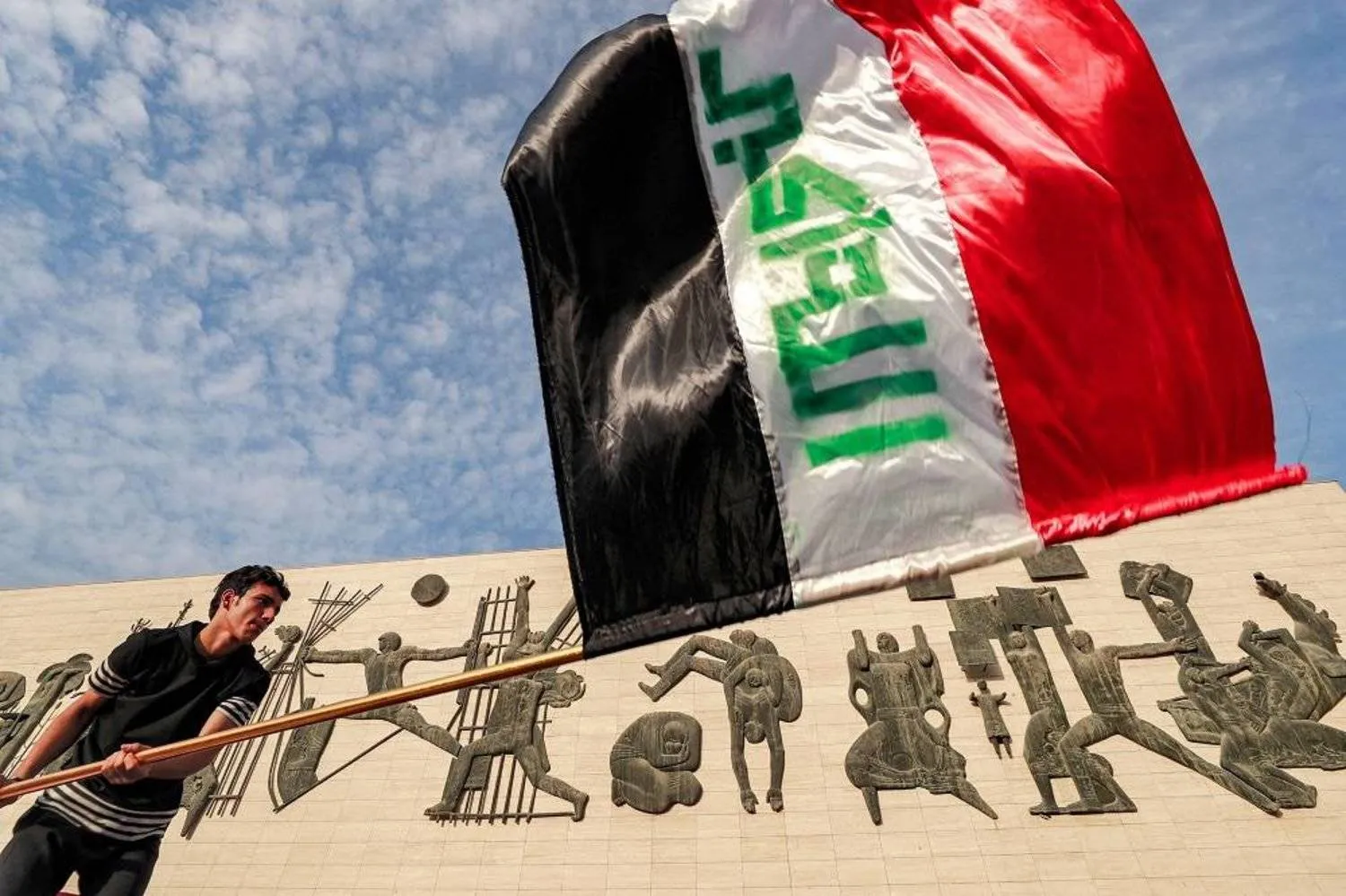 Protester holding Iraqi flag - File Photo/Reuters. 