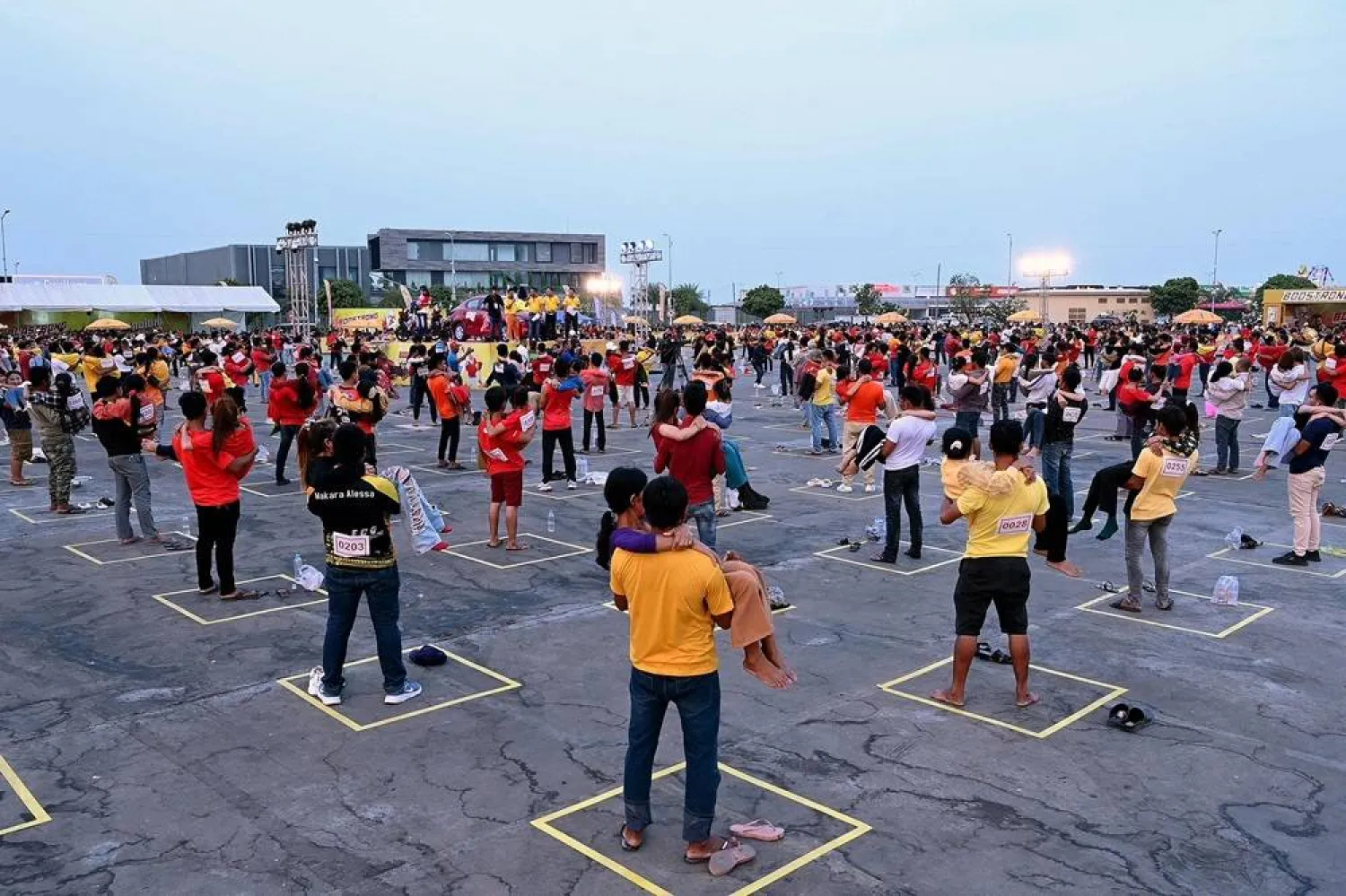 Men carry women as a test ahead of a competition and Guinness World Record attempt in Phnom Penh on March 8, 2024. (AFP)