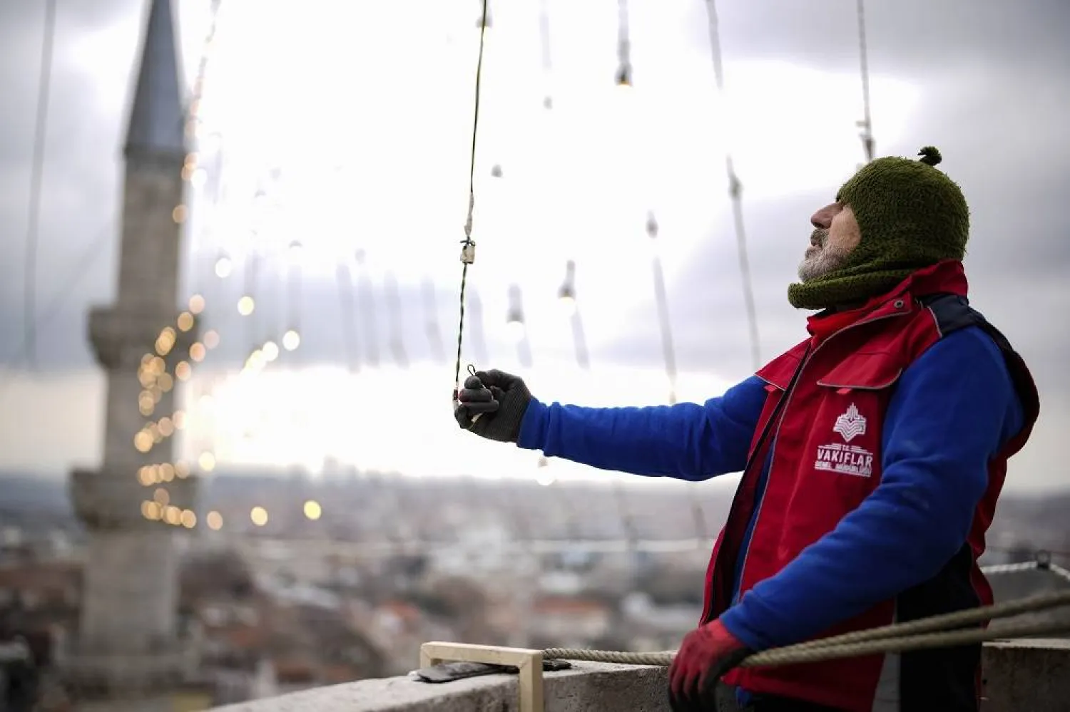 Mahya master Kahraman Yildiz works in the installation of a lights message at the top of one of the minarets of the Suleymaniye mosque ahead of the Muslim holy month of Ramadan, in Istanbul, Türkiye, Wednesday, March 6, 2024. 
