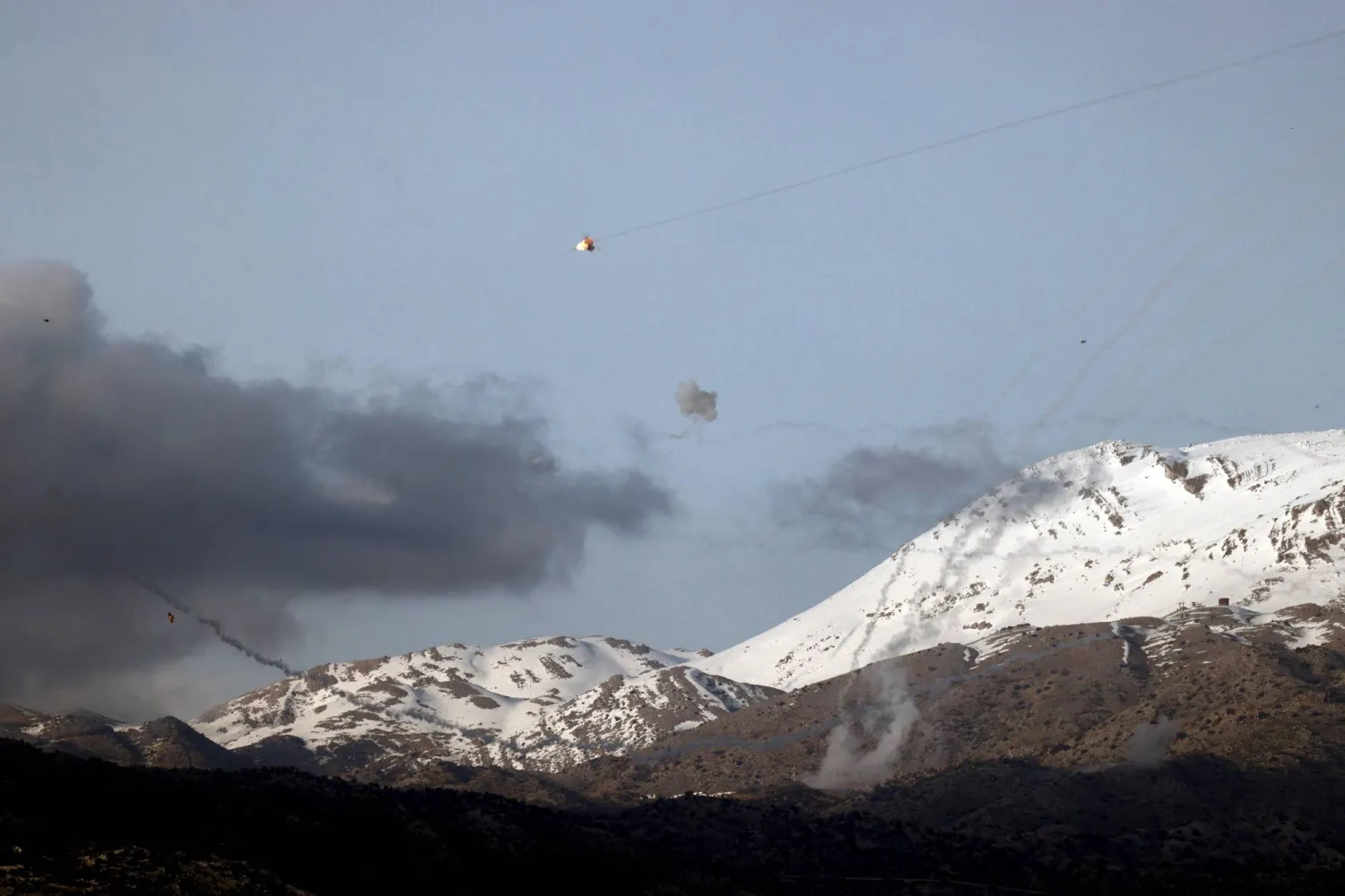 This picture taken from a position in northern Israel shows Israel's Iron Dome missile defense system intercepting rockets fired from south Lebanon over the Har Dove area on March 10, 2024, amid increasing cross-border tensions between Lebanon's Hezbollah and Israel as fighting continues with Hamas in the Gaza Strip. (Photo by Jalaa MAREY / AFP)