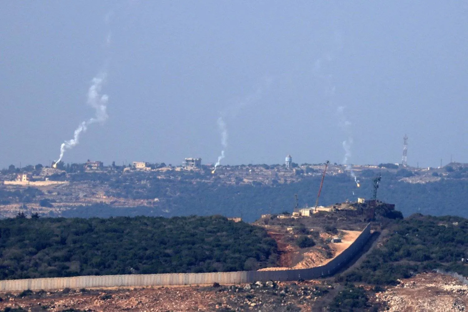 Flares are fired from northern Israel over the southern Lebanese border village of Aita al-Shaab, on October 28,2023. (Photo by FADEL SENNA / AFP)
