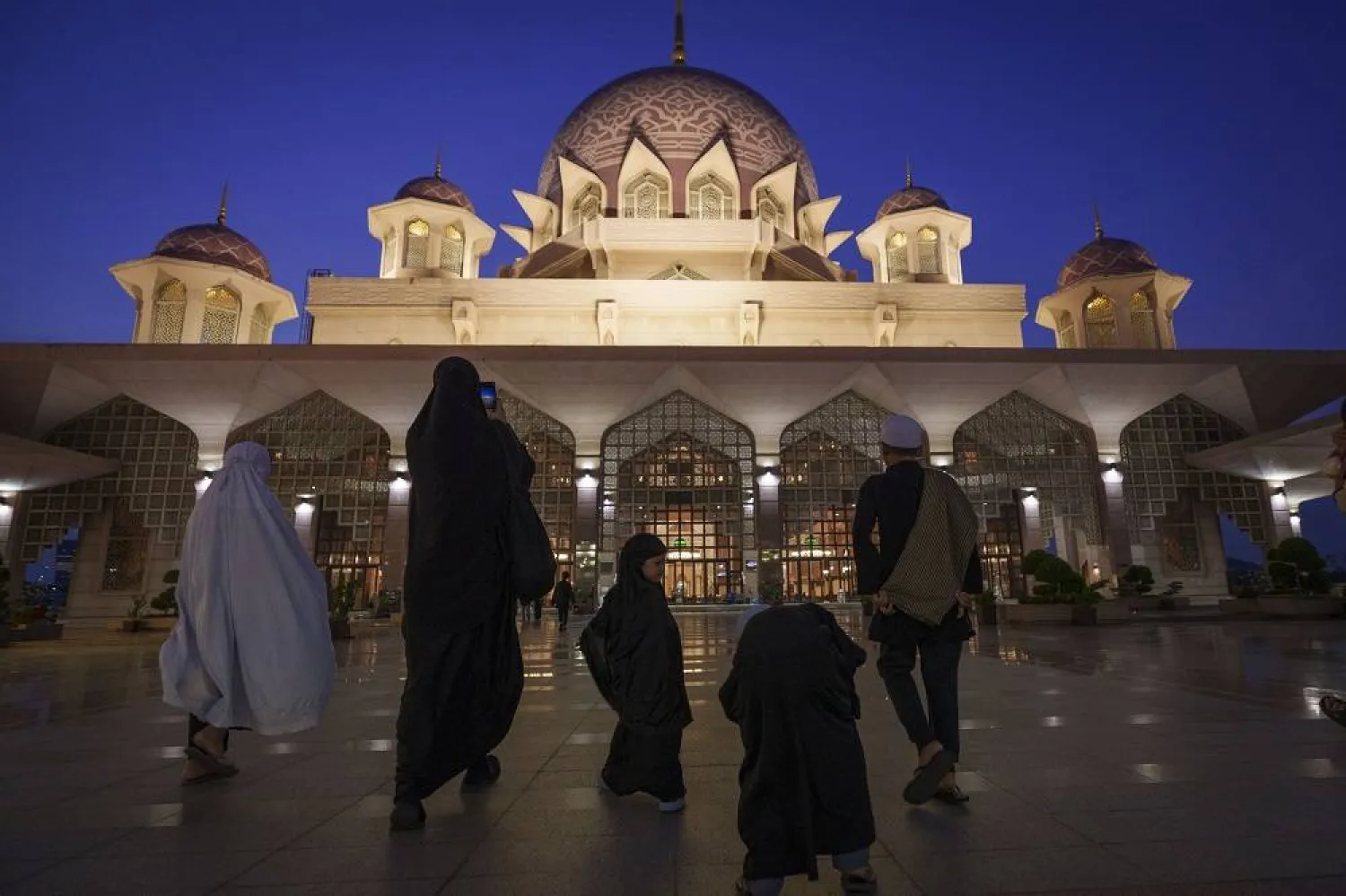 Muslims walk in Putra Mosque for prayer during sunset ahead of the holy fasting month of Ramadan in Putrajaya, Malaysia, Monday, March 11, 2024. (AP)