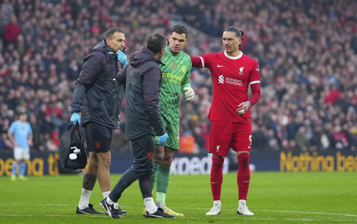 Manchester City's goalkeeper Ederson leaves the pitch after an injuring during the English Premier League soccer match between Liverpool and Manchester City, at Anfield stadium in Liverpool, England, Sunday, March 10, 2024. (AP)