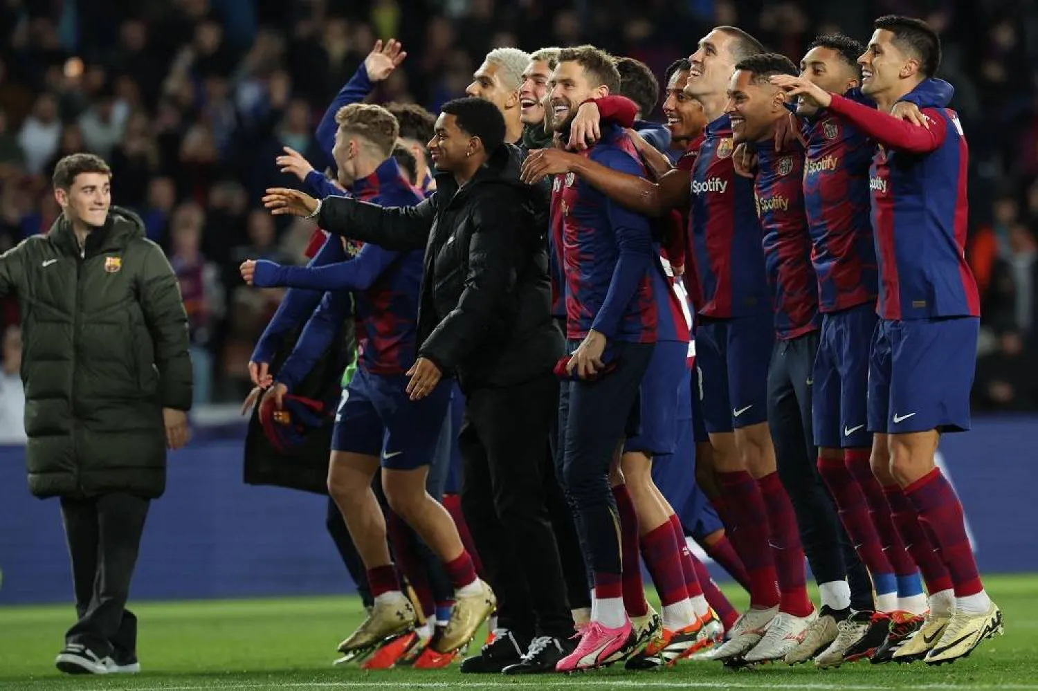 Barcelona players celebrate their win at the end of the UEFA Champions League last 16 second leg football match between FC Barcelona and SSC Napoli at the Estadi Olimpic Lluis Companys in Barcelona on March 12, 2024. (AFP)
