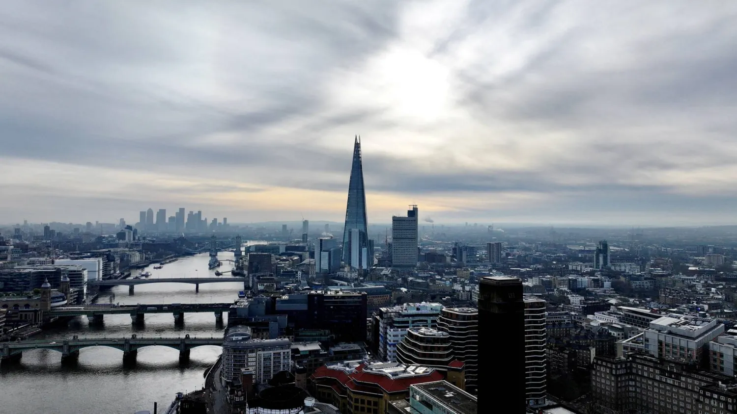 FILE PHOTO: A drone view of London's Shard skyscraper with the Canary Wharf financial district in the background in London, Britain March 3, 2024. REUTERS/Yann Tessier/File Photo