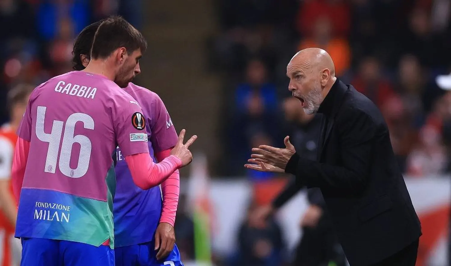 AC Milan head coach Stefano Pioli (R) gives instructions to his player Matteo Gabbia (L) during the UEFA Europa League Round of 16, second leg soccer match between SK Slavia Prague and AC Milan, in Prague, Czech Republic, 14 March 2024. (EPA)