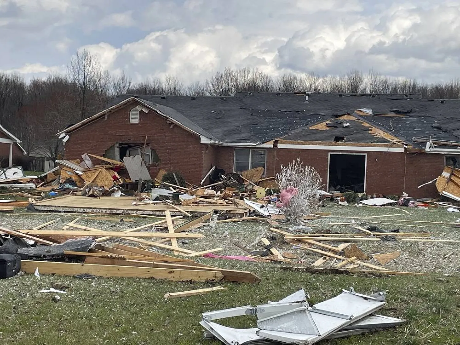 Debris covers the ground in front of a damaged home after severe weather passed the area on Thursday, March 14, 2024 in Jefferson Manor Subdivision near Hanover, Ind. (Sgt. Stephen Wheeles/Indiana State Police via AP)
