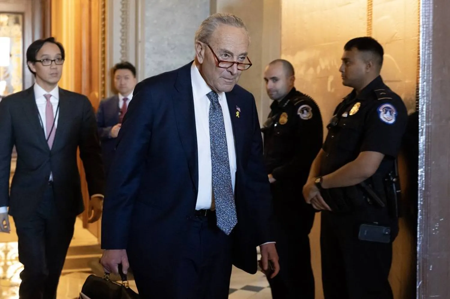  US Senate Majority Leader Chuck Schumer (C) leaves the Senate chamber following a Senate vote on Capitol Hill in Washington, DC, USA, 14 March 2024. (EPA)
