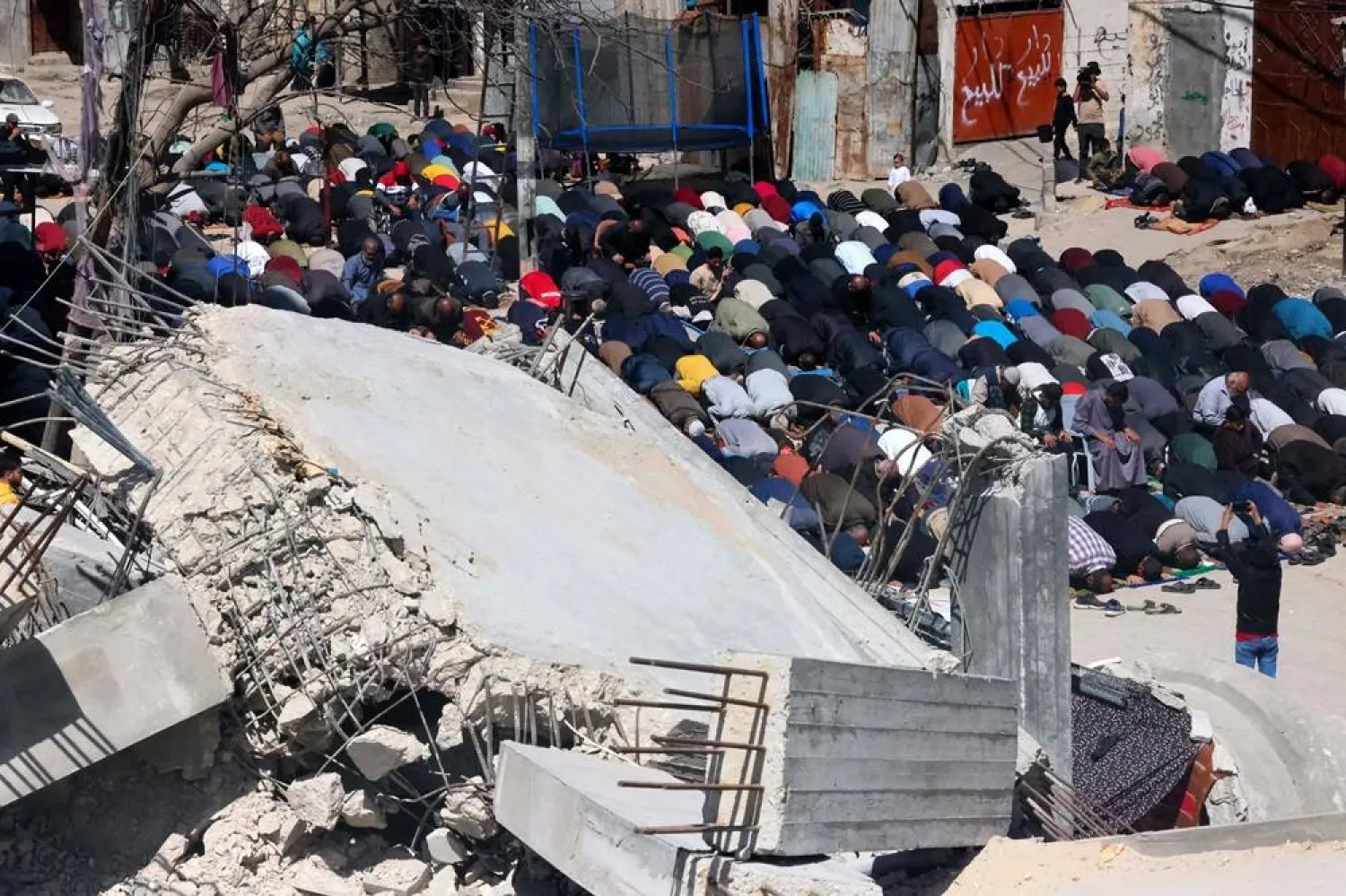 Palestinians perform the first Friday noon prayer of the Muslim holy fasting month of Ramadan in front of the ruins of Al-Farouq Mosque on March 15, 2024, destroyed in Israeli bombardment in Rafah in the southern Gaza Strip, amid ongoing battles between Israel and Hamas. (AFP) 
