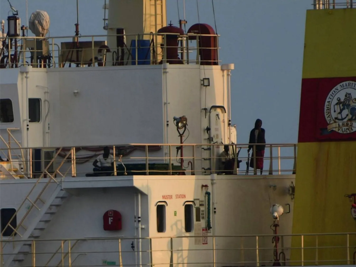 People with weapons stand onboard the Maltese-flagged bulk cargo vessel Ruen seized by Somali pirates, which was intercepted by the Indian Navy, at sea, in this handout photo released on March 16, 2024. SpokespersonNavy via X /Handout via REUTERS