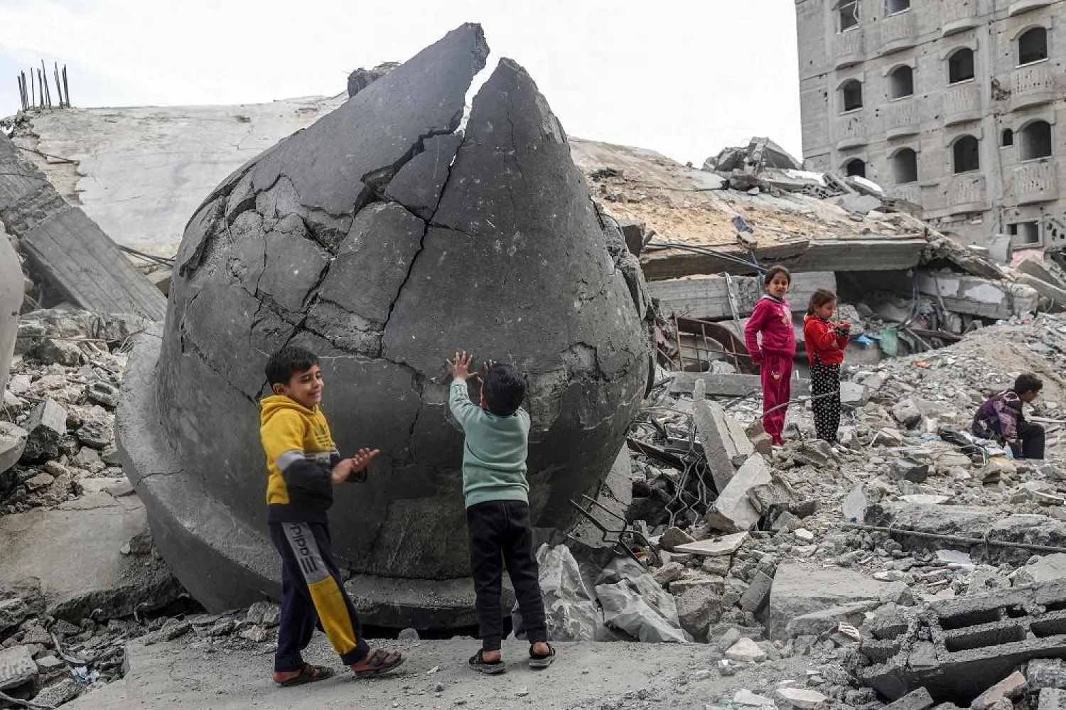 Children play in the rubble of Al-Faruq Mosque, that was destroyed during Israeli bombardment, in Rafah on the southern Gaza Strip on March 17, 2024, amid ongoing battles between Israel and Hamas. (AFP)
