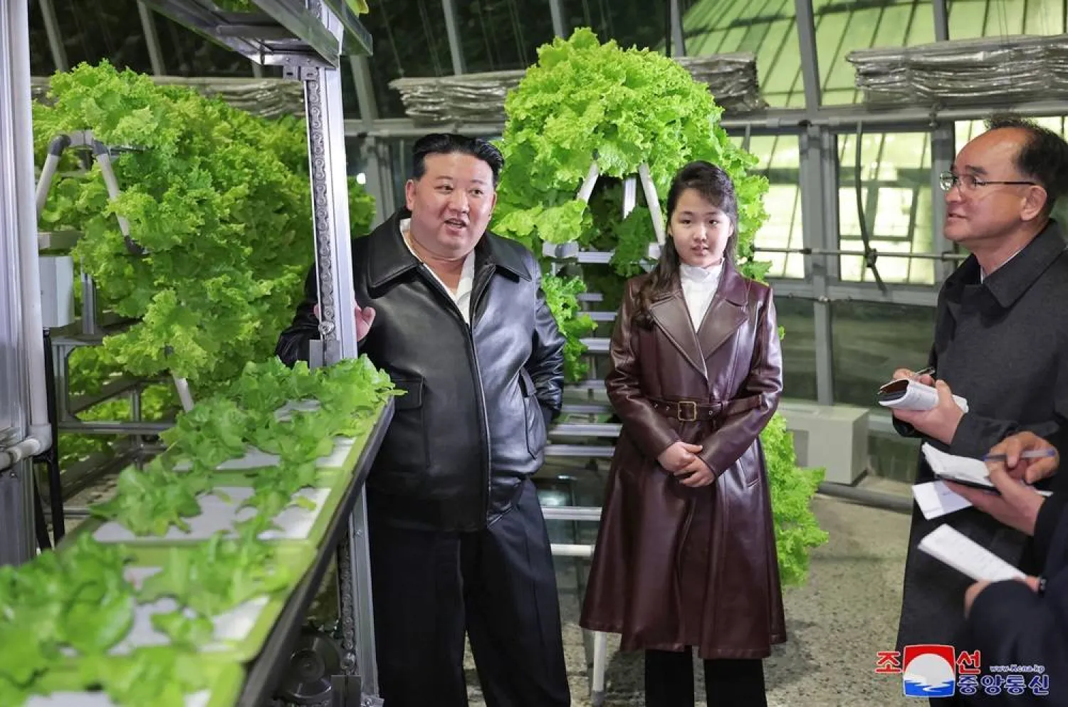 This picture taken on March 15, 2024 and released from North Korea's official Korean Central News Agency (KCNA) on March 16 shows North Korean leader Kim Jong Un (L) and his daughter Ju Ae (2nd R) visiting the Gangdong Comprehensive Greenhouse in Pyongyang. (Photo by KCNA VIA KNS / AFP) 