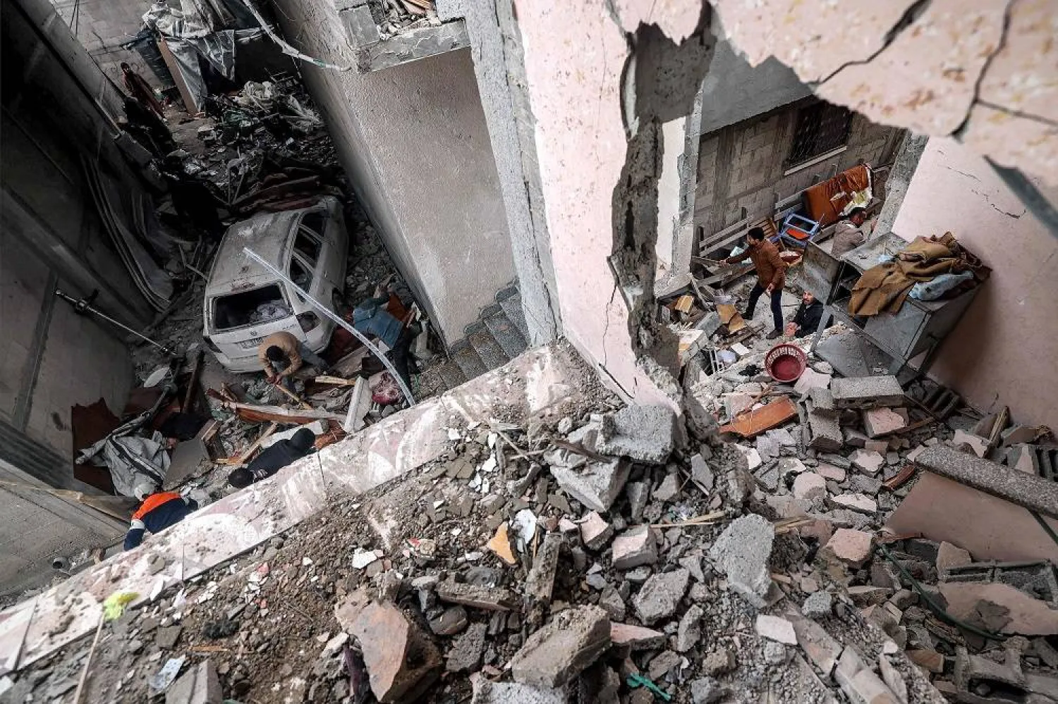 People search the rubble and debris of a building that was hit by Israeli bombardment late the previous night in Rafah in the southern Gaza Strip on March 19, 2024 amid the ongoing conflict in the Palestinian territory between Israel and Hamas. (AFP)