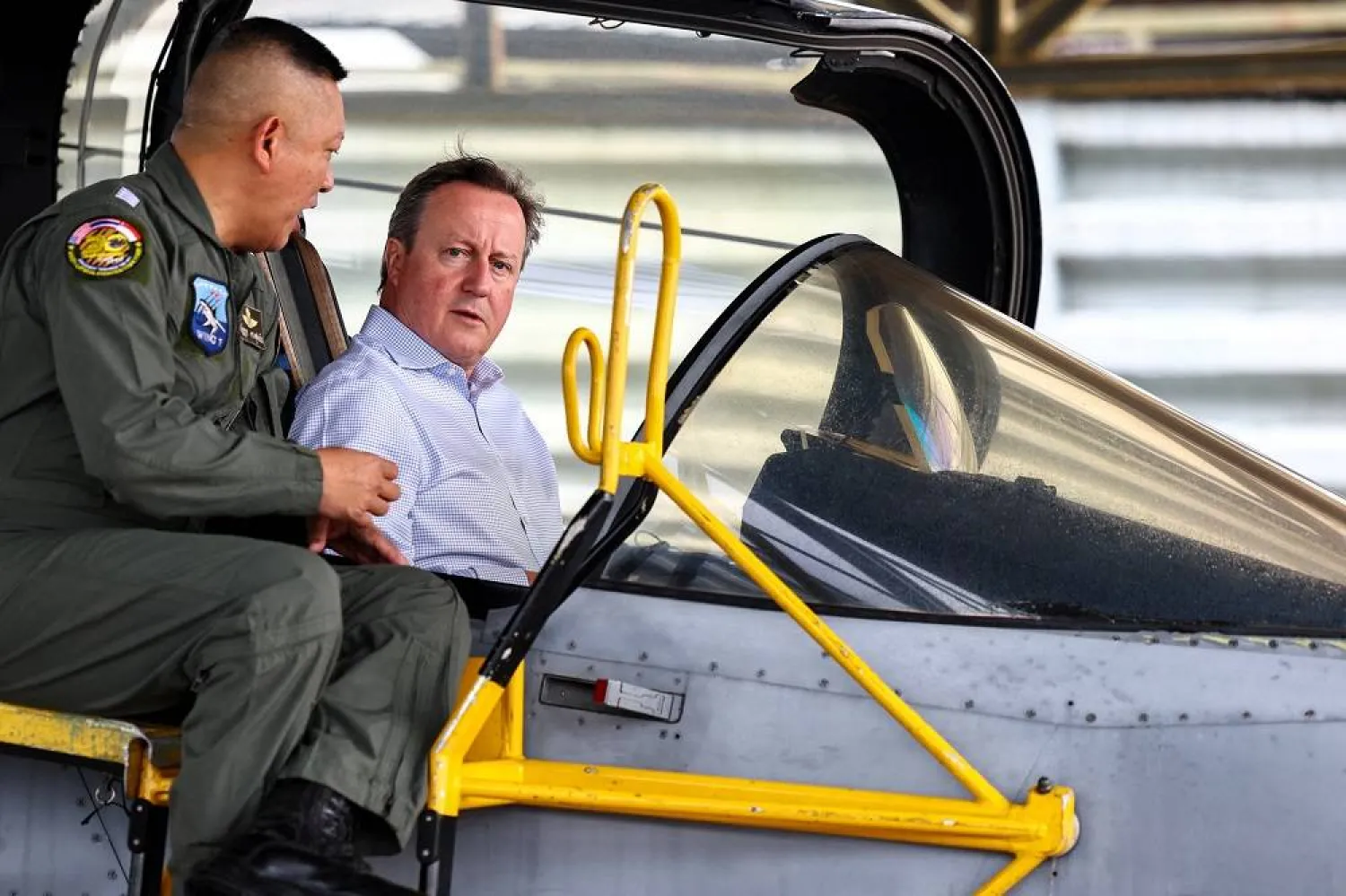 British Foreign Secretary and former Prime Minister David Cameron talks to a pilot as he sits in the cockpit of a Gripen fighter jet on the sidelines of an interview with Reuters at an Air Force Base in Nakhon Ratchasima province, Thailand, March 20, 2024. (Reuters)