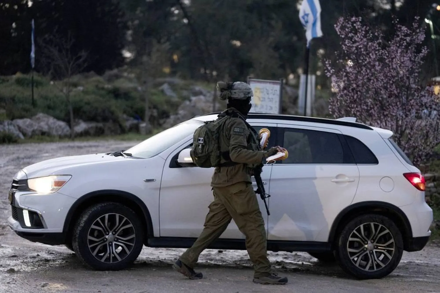 An Israeli soldier secures the entrance to a forest area that was the site of a shooting near the West Bank settlement of Migdal Oz, Tuesday, March 19, 2024. (AP)