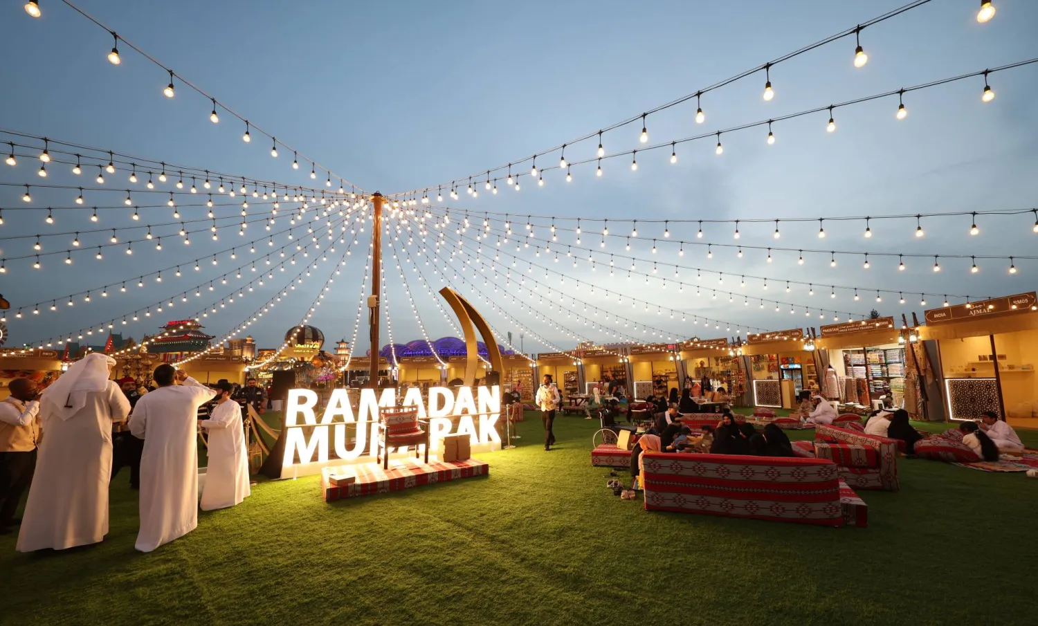 People break their fast after sunset in the Ramadan Market section at the Global Village in the Gulf Emirate of Dubai, United Arab Emirates, 19 March 2024.  EPA/ALI HAIDER