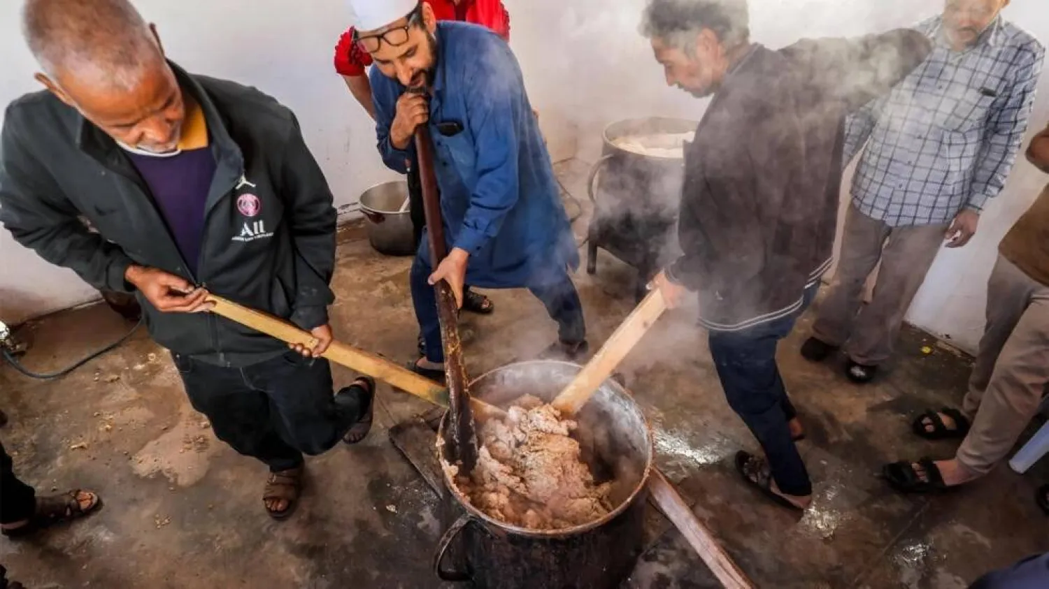 Bazin was traditionally cooked at home in Libya, but these volunteers make it for their community during Ramadan. Mahmud Turkia / AFP
